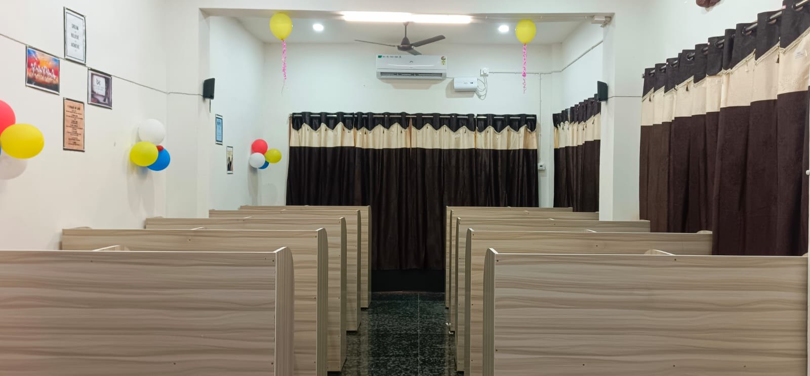 Inside Karmashila Library & Classes in Baharagora, showing individual study cubicles, air conditioning and a quiet study environment